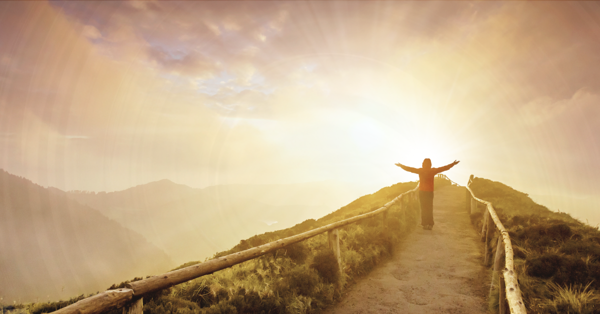 Walking Toward a Smoke-Free Future Symbol of New Beginnings A person walking on a mountain path toward a bright sunrise, symbolizing new beginnings and a smoke-free life.
